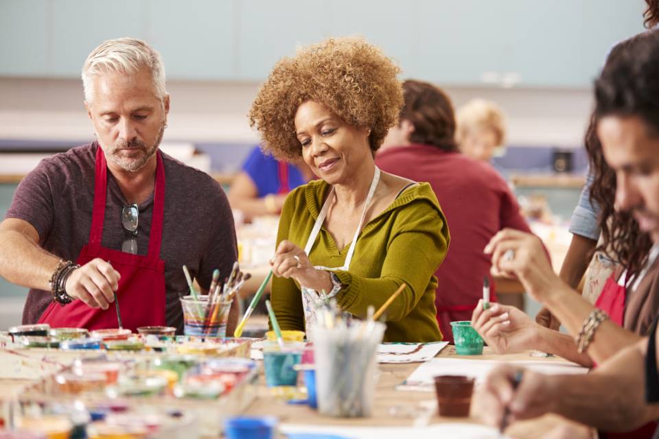 Group of mature adults attending art class in community centre